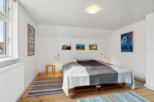 a bedroom with a bed and a window at Cozy Holiday Home In Marstal On Ærø in Marstal
