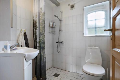 a bathroom with a toilet and a sink and a shower at Holiday Apartment In Peaceful Surroundings in Neksø