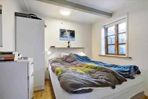 a large bed in a room with a window at Holiday Apartment In Peaceful Surroundings in Neksø