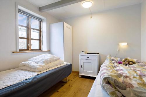 a small bedroom with a bed and a window at Holiday Apartment In Peaceful Surroundings in Neksø