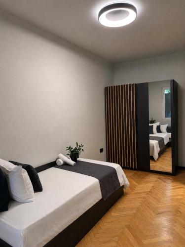 a bedroom with two beds and a large mirror at Avliga Designer Residence in Varna City