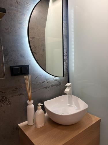 a bathroom with a white sink and a mirror at Avliga Designer Residence in Varna City