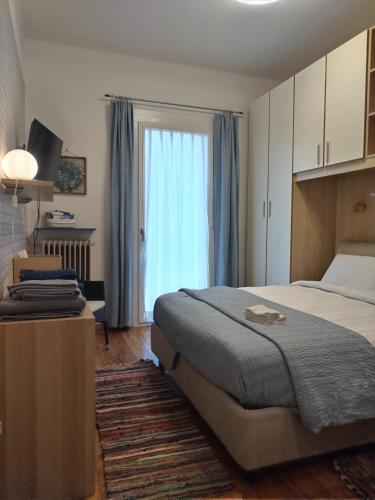 a bedroom with a bed and a large window at La casetta di Elena - Sondrio Valtellina in Sondrio