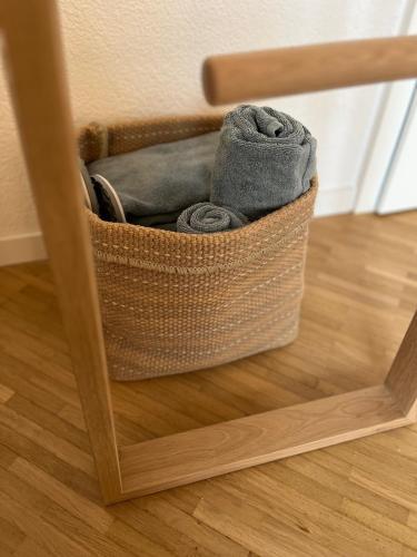 a basket of clothes sitting on the floor in a mirror at B&B Alpenblick in Erlinsbach