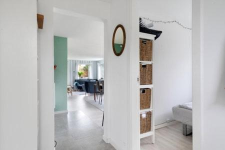 a white room with a mirror on a wall at Beautiful Holiday Home On An Undisturbed Plot in Rødby