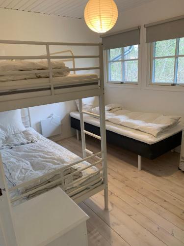 a room with two bunk beds and a lamp at Charming Holiday Home At Sought-After Tisvilde in Vejby