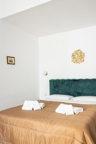 a large bed with two towels on top of it at B&B Faraglione in Lipari