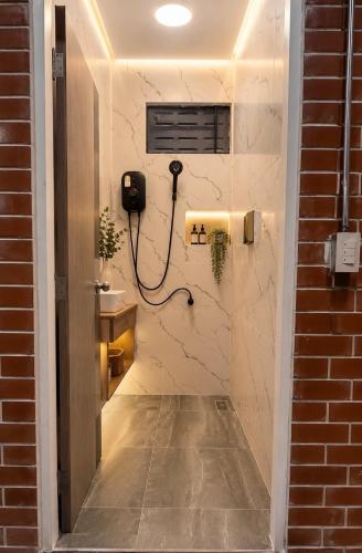 a bathroom with a phone on a wall at Koh Tao Silver Na’s Hostel in Ko Tao
