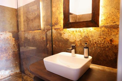 a bathroom with a white sink and a mirror at Moin Moin Boutique Hotel in Berat