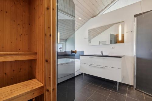 a kitchen with white cabinets and a sink at Activity House - Flovt Strand Haderslev in Haderslev
