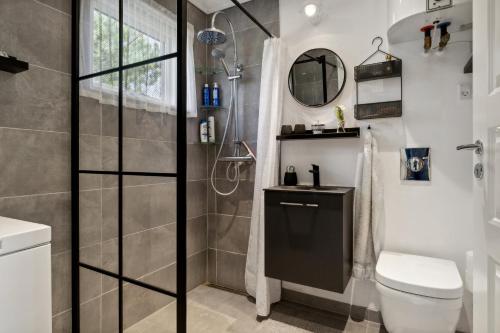 a bathroom with a shower and a toilet and a sink at Cozy Cottage Only 500 M From The Sea in Gilleleje