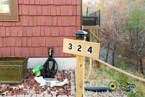 a house with a sign in front of a house at 324 Brian Drive: The Swirling Bird in Basye