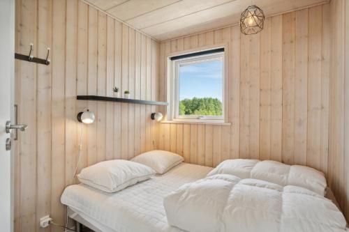 a bed in a room with a window at Lovely Summer House In Haderslev in Haderslev