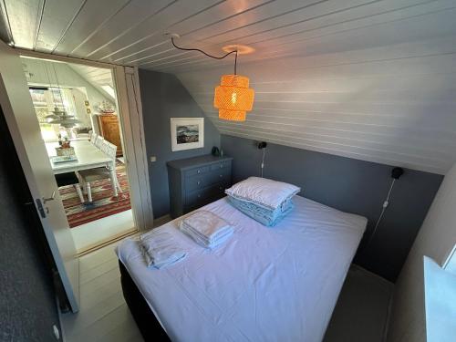 a small bed in a small room with a window at Cozy Holiday Home With Character in Nakskov