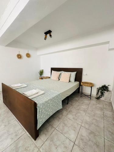 a bedroom with a large bed in a white room at infinity sky stay in episkopi-heraklion