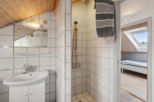 a bathroom with a sink and a shower at Summer House On Beautiful Rømø in Sønderby