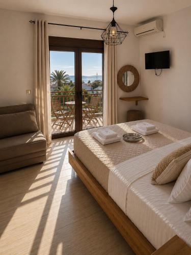 a bedroom with a large bed and a balcony at Anthoula House Sarti in Sarti