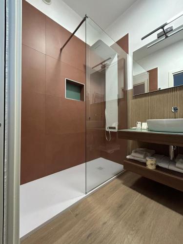a bathroom with a glass shower and a sink at I Cordari B&B in Vieste