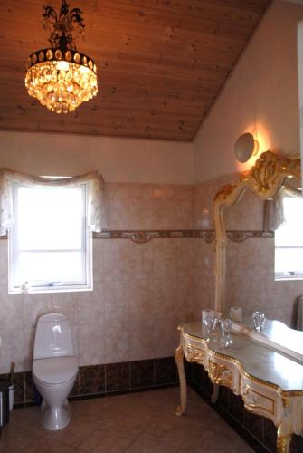 a bathroom with a toilet and a chandelier at Outstanding Close To Nice Beachh in Karrebæksminde