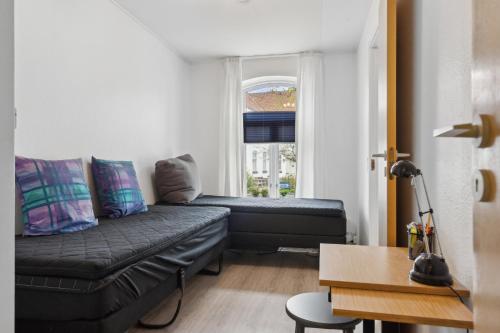 a living room with a couch and a window at Cozy Apartment In Tønder in Tønder