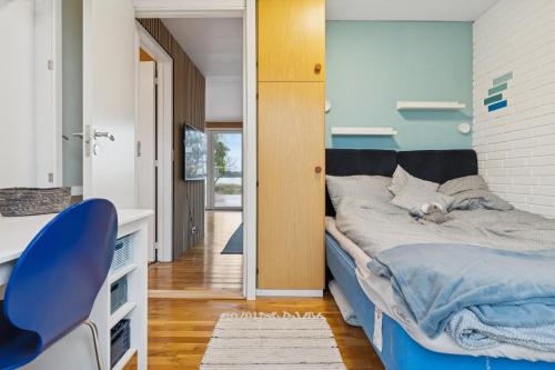 a bedroom with a bed with a dog laying on it at Summer House With Fjord View in Kulhuse