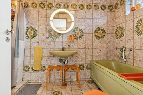 a bathroom with a sink and a tub and a mirror at Summer House With Fjord View in Kulhuse
