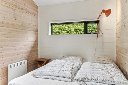 two beds in a bedroom with a window at Scenic Summer House In Asserbo in Frederiksværk