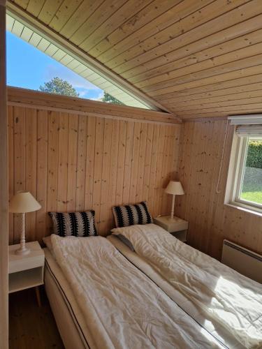 a large bed in a room with a window at Cozy And Well-Maintained Holiday Home in Eskebjerg