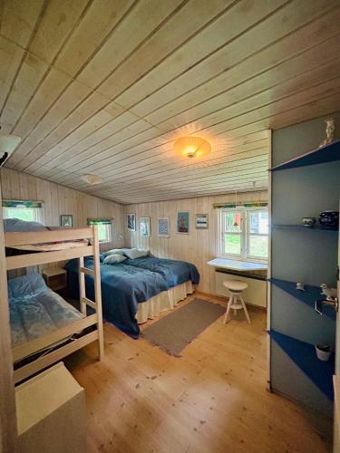 a bedroom with two bunk beds and a desk at Togetherness Coziness Magical Great Belt View in Tranekær