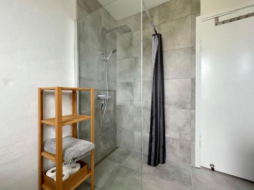 a bathroom with a shower with a glass door at Charming Holiday Apartment In Central Stege in Stege
