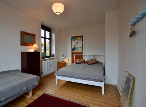 a bedroom with two beds and a window at Charming Holiday Apartment In Central Stege in Stege