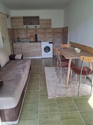 a living room with a couch and a table with chairs at Apartment Moki in Lastva