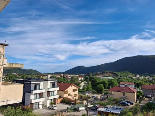 a view of a city with mountains in the background at Apartment Moki in Lastva