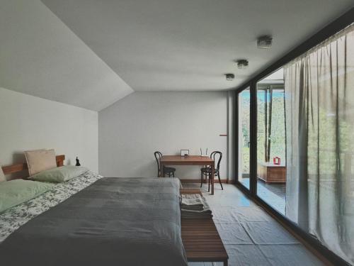 a bedroom with a bed and a table at W Pelniku in Pelnik