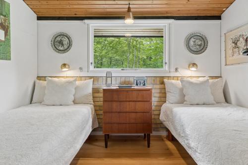 a bedroom with two beds and a window at Nostalgic 1960S Idyll in Kulhuse