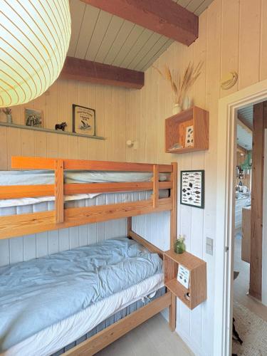 a bedroom with bunk beds in a house at Simple Summer Living In Magical Setting in Nykøbing Sjælland