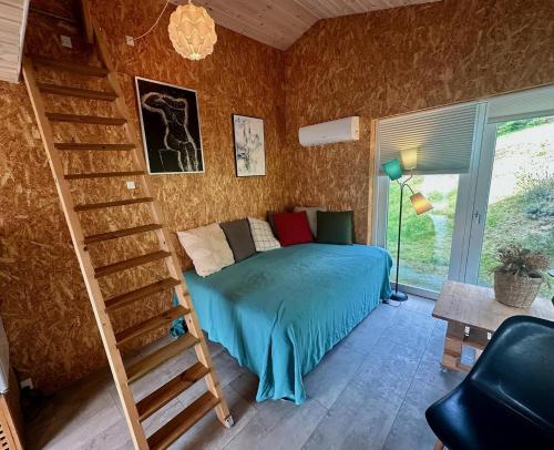 a bedroom with a bed and a staircase in a room at Small Oasis Near Coast And Town in Ebeltoft