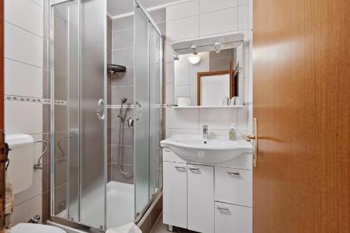 a bathroom with a shower and a sink at Guesthouse Marija II in Lopar