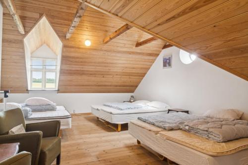 a room with three beds in a attic at Margretehøj Manor In Scenic Surroundings in Grenå