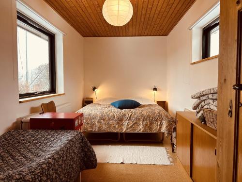 a bedroom with two beds and a window at Charming And Cozy Cottage in Tranekær