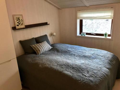 a bedroom with a bed and a window at Fantastic House With A Beautiful View in Ebeltoft