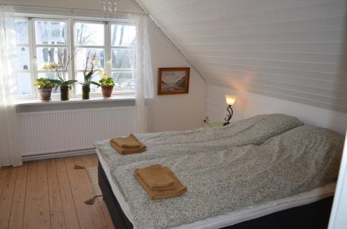 a bedroom with a bed with two towels on it at Large Holiday Home In Seaside Hotel Style in Ans