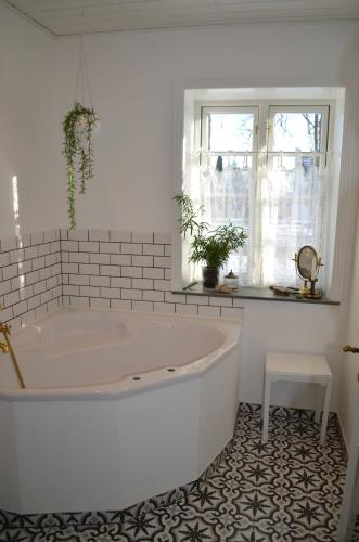 a white bath tub in a bathroom with a window at Large Holiday Home In Seaside Hotel Style in Ans