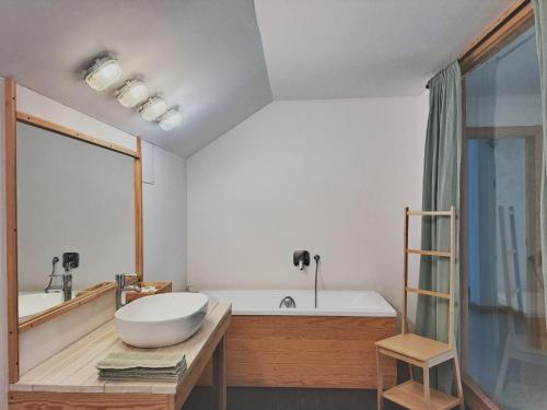 a bathroom with a large tub and a sink at W Pelniku in Pelnik