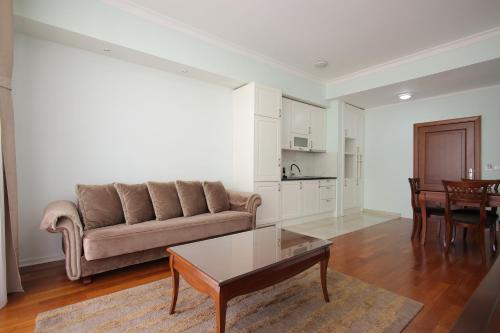 a living room with a couch and a table at Apartman A4 - Dvorac Belimarkovic in Vrnjačka Banja