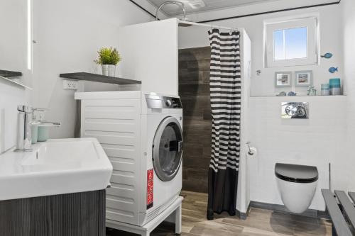 a bathroom with a washing machine and a sink at Super Nice Holiday Home With Whirlpool in Højslev