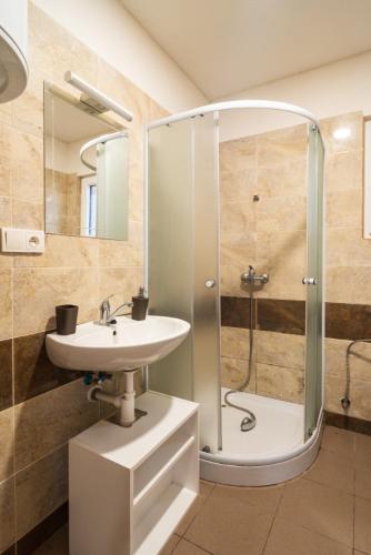 a bathroom with a shower and a sink and a shower at Autokemp Křivonoska in České Budějovice