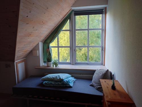 a bed in a room with a large window at Idyllic Half-Timbered House For 10 Guests in Kettinge