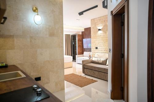 a bathroom with a sink and a living room at Villa LaMia in Ulcinj