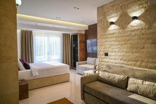 a hotel room with a bed and a couch at Villa LaMia in Ulcinj